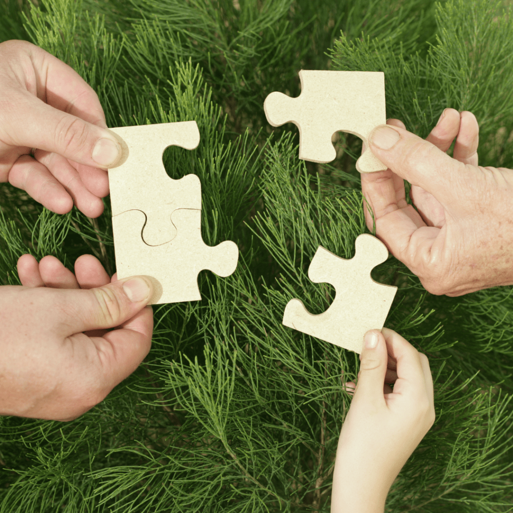 Hands holding puzzle pieces
